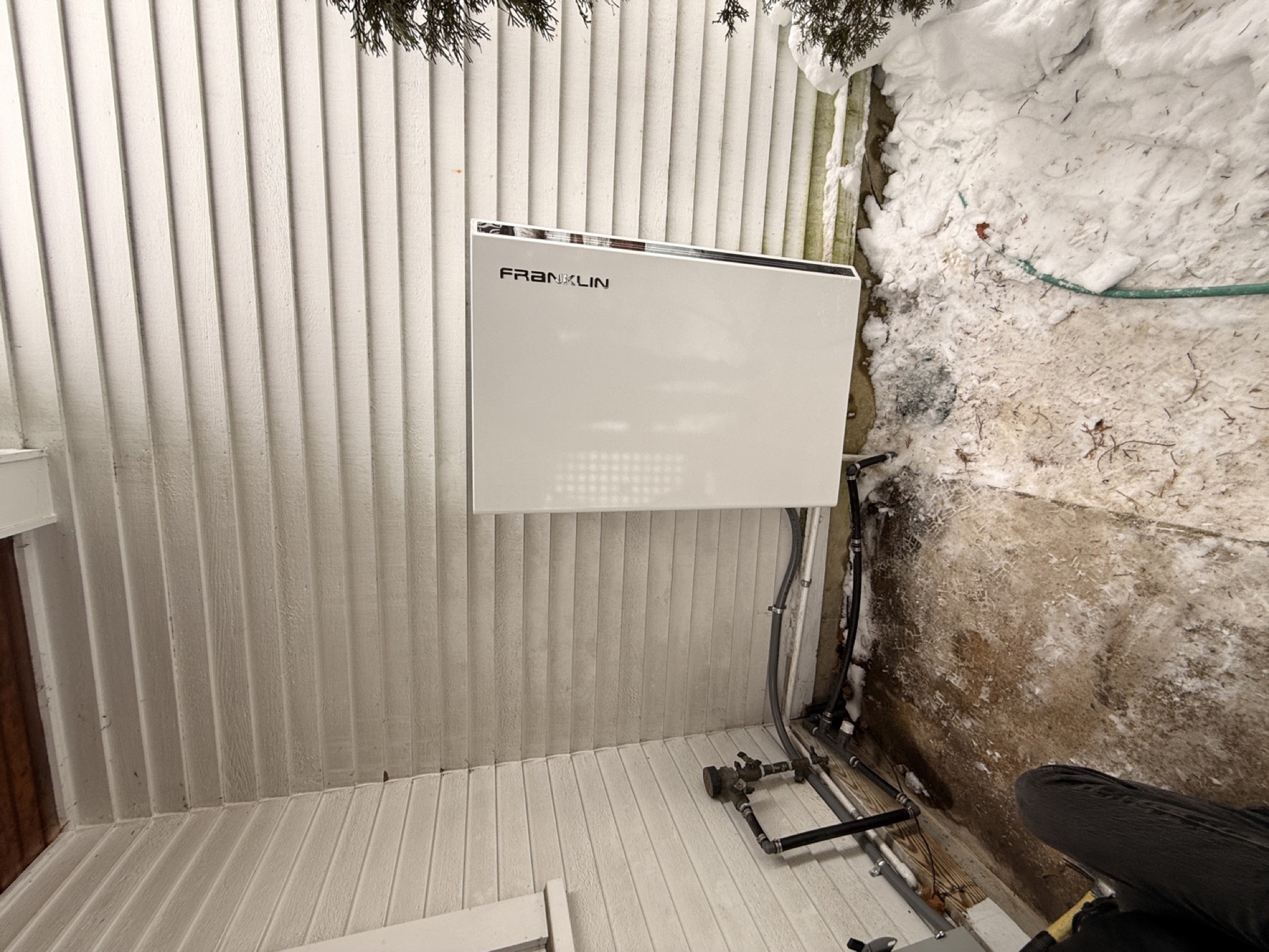 FranklinWH home battery installed on an exterior wall in winter