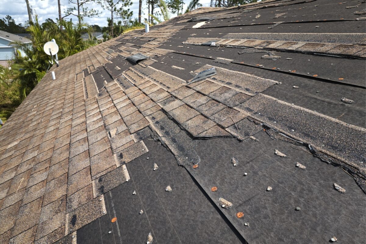 A worn old roof being torn off before replacement