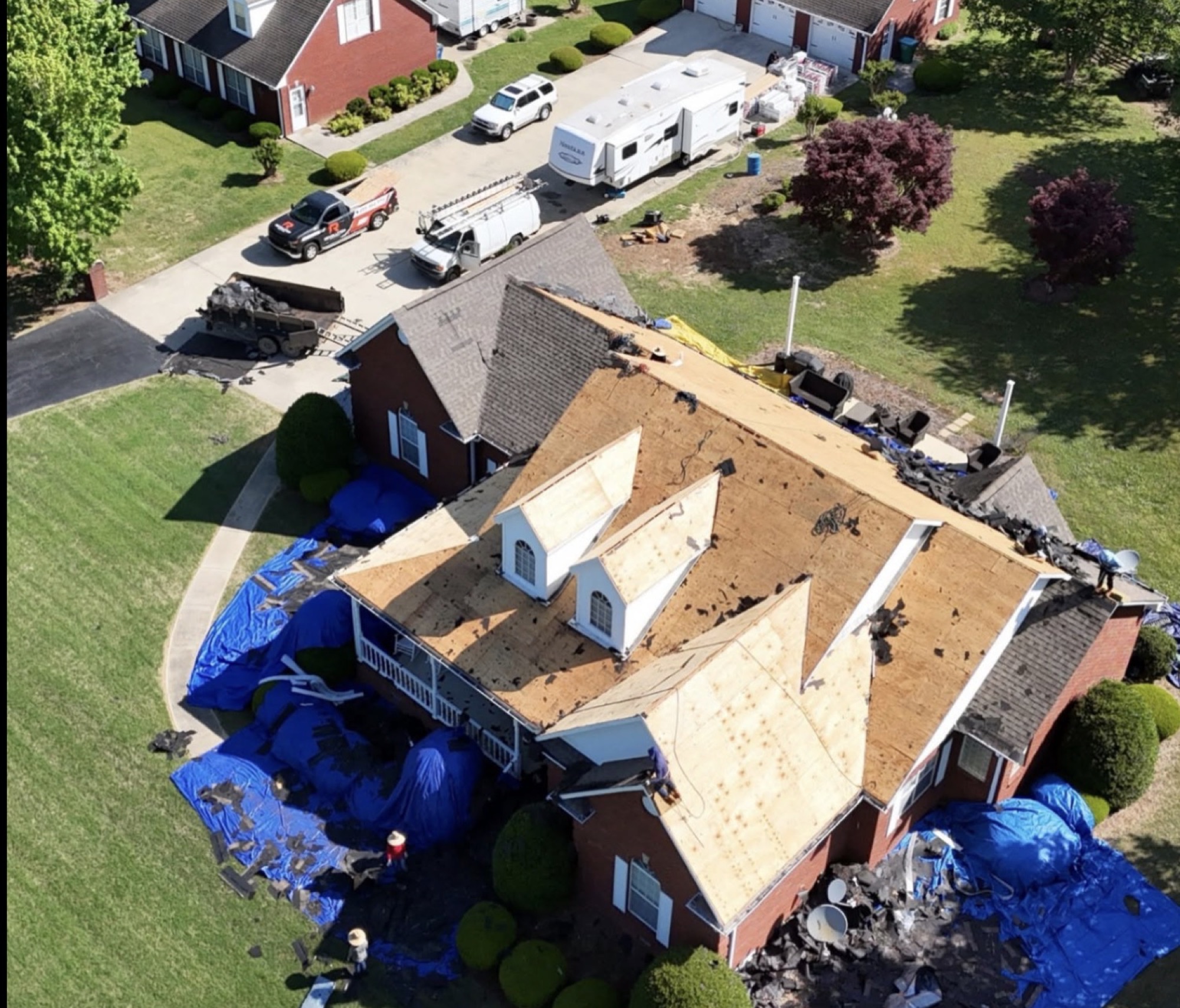Aerial view of a home mid roof replacement by Nexis