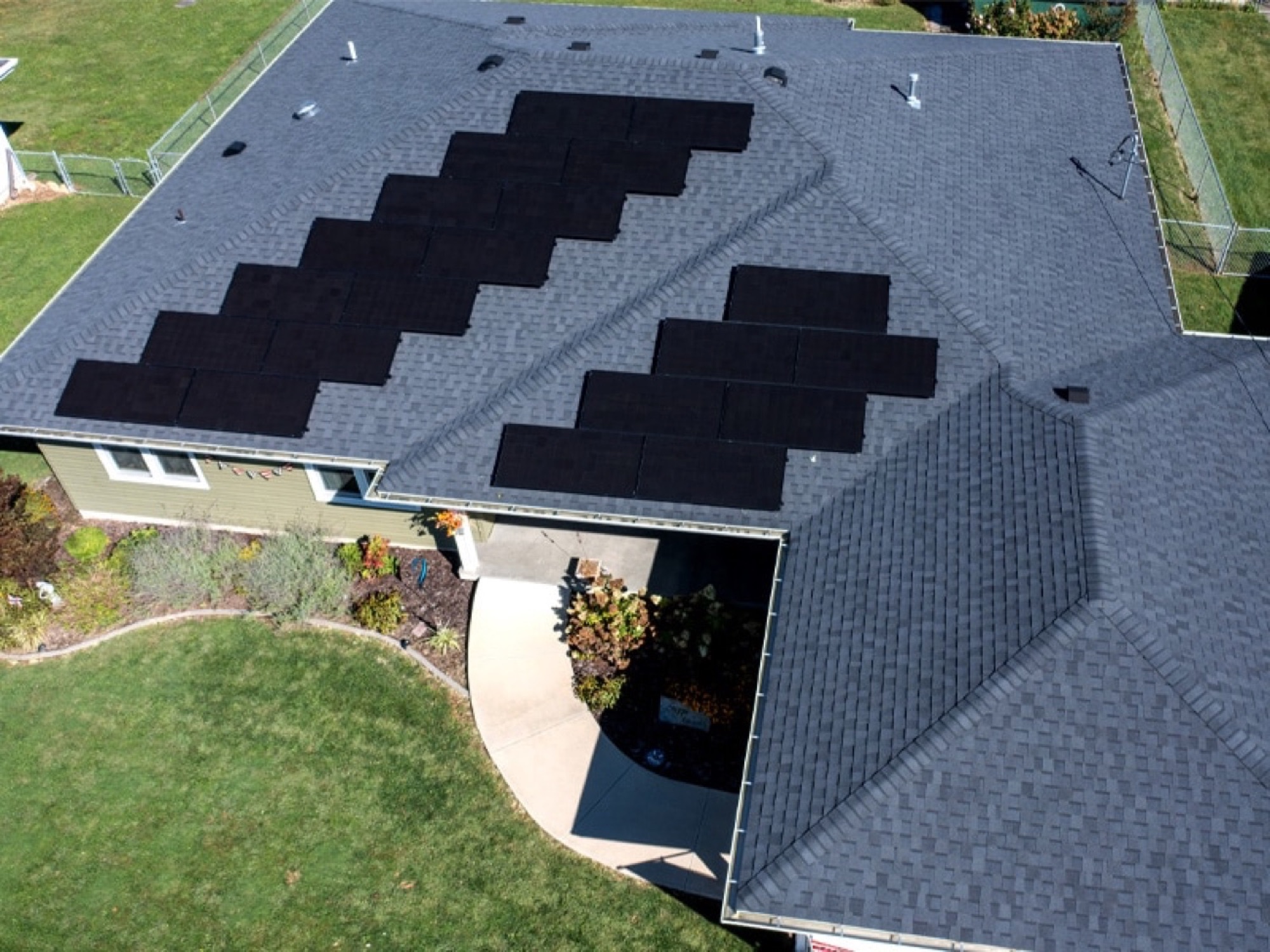Aerial of a new architectural shingle roof with solar panels