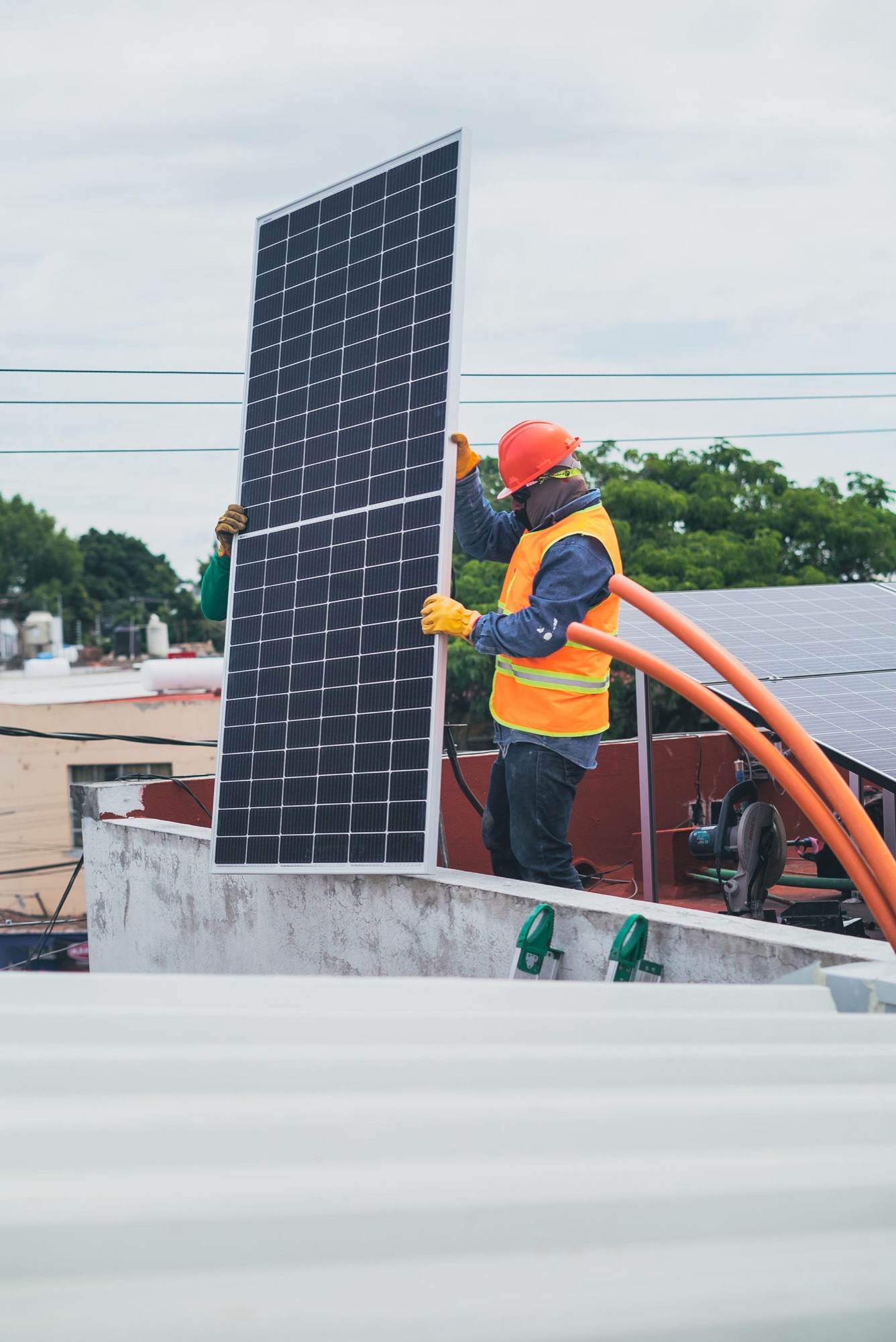Solar installers on a rooftop — Nexis partner program